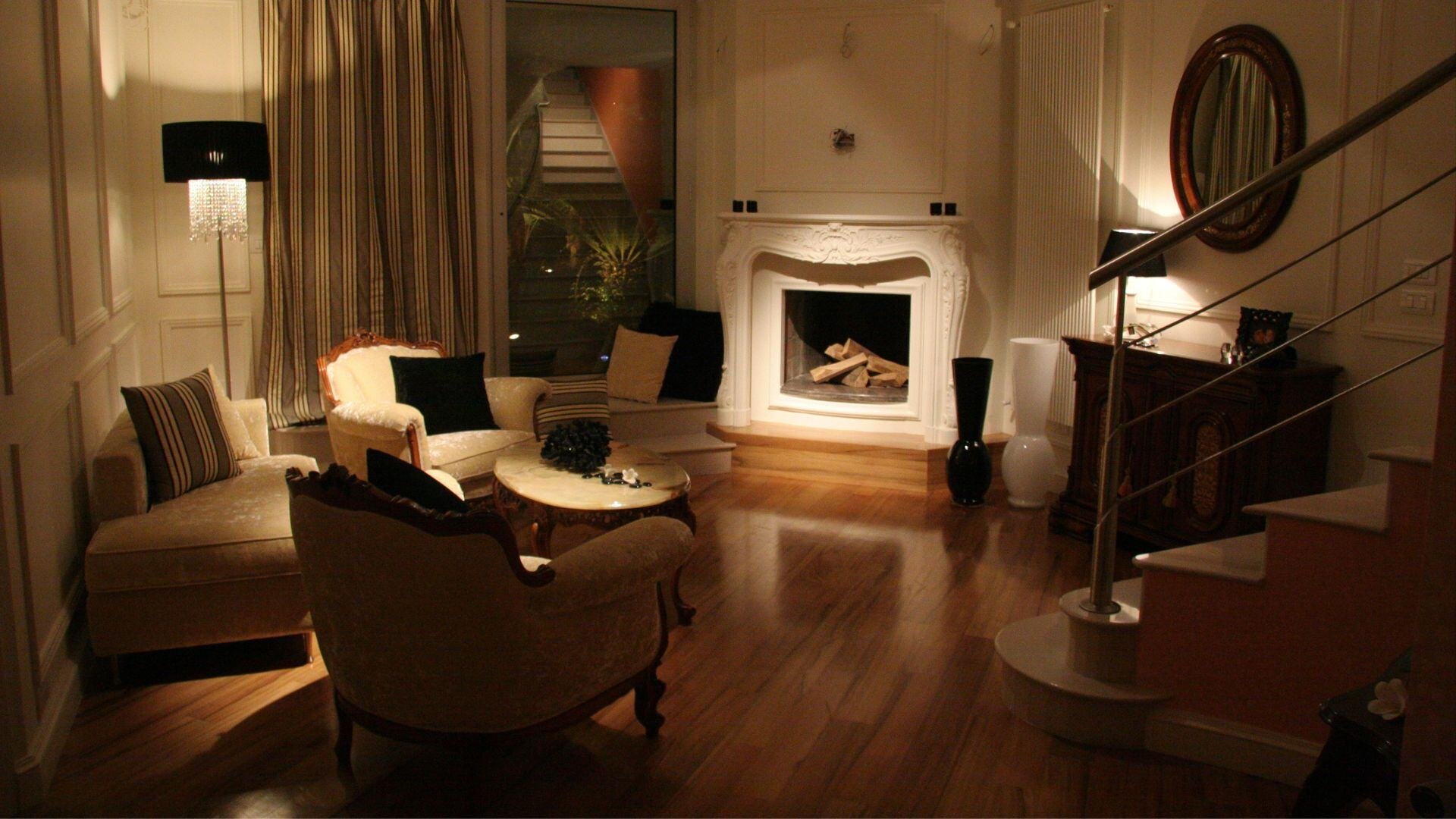 Warm and inviting bespoke living room with classic furniture, ambient lighting, and elegant architectural detailing