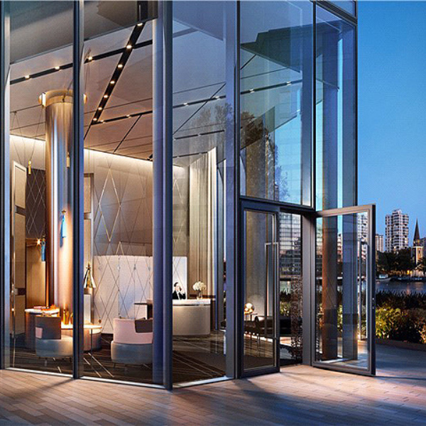 Luxury glass-façade entrance featuring bespoke interior design, premium materials, and seamless architectural detailing. Ideal for high-end property developers and bespoke fit-out projects in the UK.