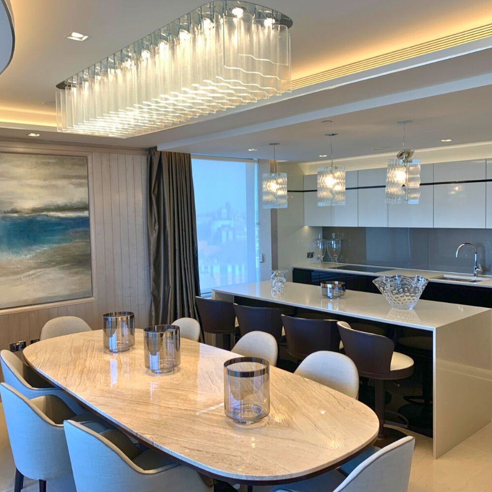 Modern bespoke kitchen remodel with sleek cabinetry and marble surfaces