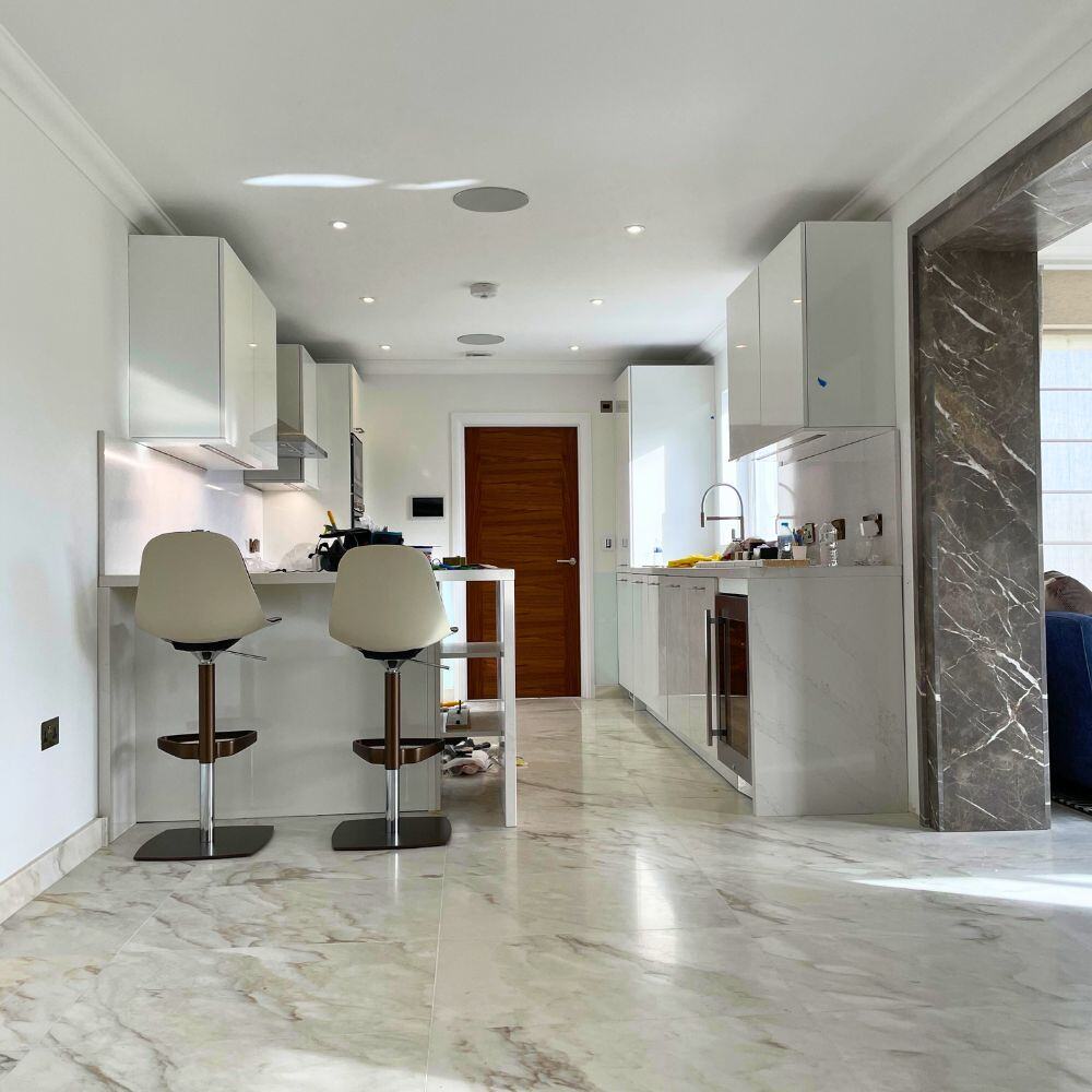 Elegant kitchen renovation with marble flooring and polished finishes